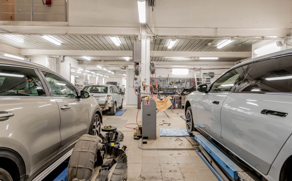 Interior of the auto repair shop with vehicles being serviced