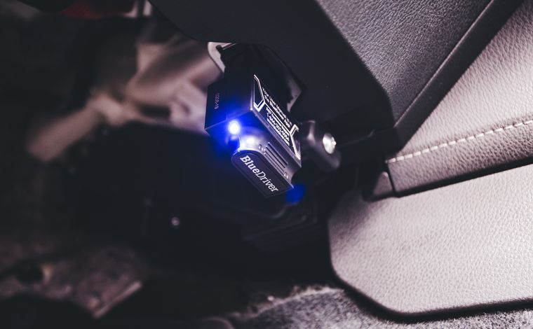 OBD diagnostic scan tool plugged into a vehicle