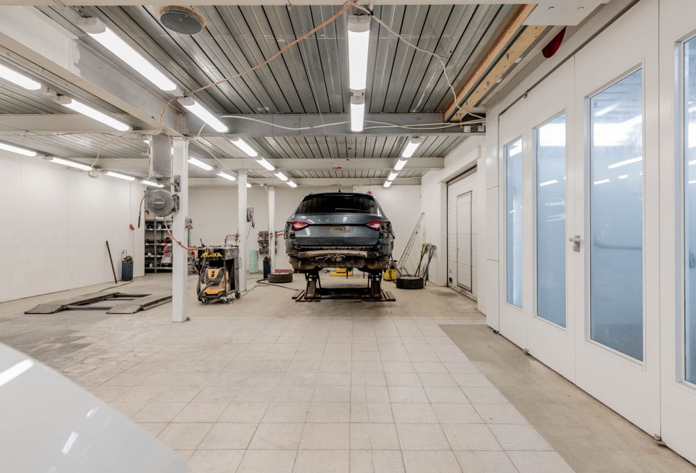 A vehicle raised on a lift in the service bay