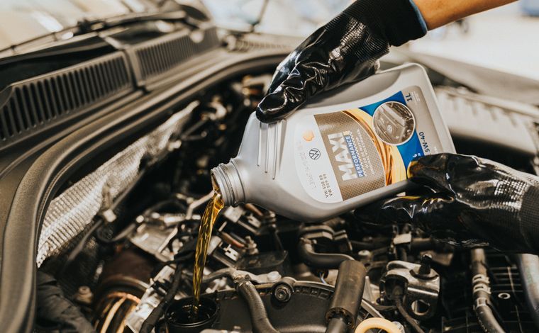 Fresh engine oil being added during an oil change